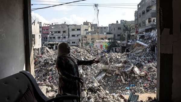 A Palestinian woman gestures as she explains how her home was destroyed during the Israeli bombardment in Gaza