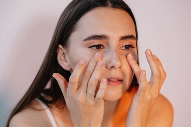 Woman applying eye cream