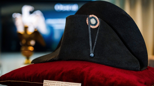The hat, known as a bicorne, is in Napoleon's trademark colours, black with the French flag's colours blue-white-red as insignia