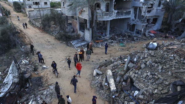 Palestinians inspect damage following an Israeli strike in Rafah, south Gaza