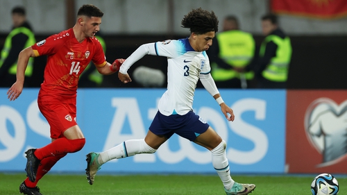 England's Rico Lewis runs with the ball whilst under pressure from Bojan Dimoski of North Macedonia