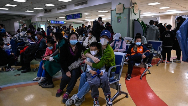 Parents and children wait to be treated at a hospital in Beijing