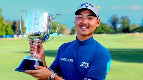 Min Woo Lee of Australia poses with his trophy following victory on home soil