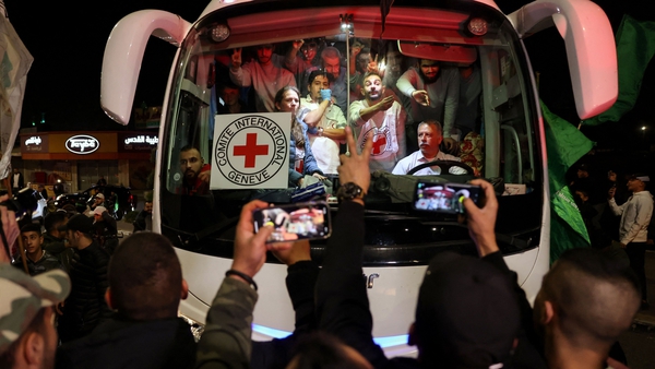 A bus transporting Red Cross staff and Palestinians released from Israeli jails drives through Ramallah in the West Bank this morning