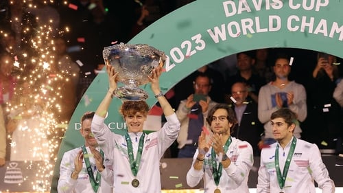 Italy's Jannik Sinner raises the trophy alongside his team-mates