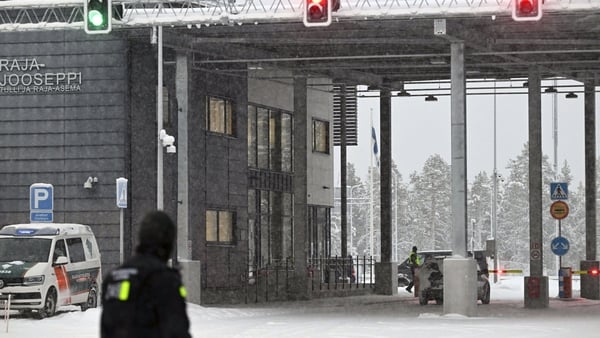 Finnish border guards stand at the Raja-Jooseppi border checkpoint between Finland and Russia