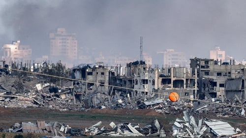A view of buildings destroyed by Israeli bombardment in central Gaza from a position across the border in southern Israel