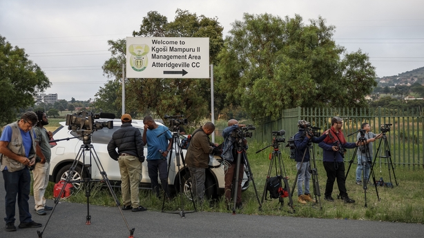 Journalists pictured outside the prison in South Africa this morning