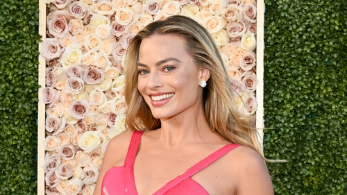 Margot Robbie looks incredible in a white swimsuit while she goes