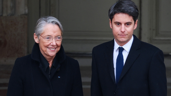 Gabriel Attal (R) is welcomed by outgoing prime minister Elisabeth Borne as he arrives for the handover ceremony in Paris