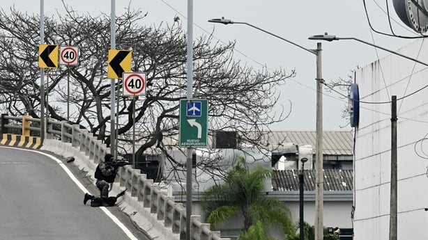 An Ecuadorean sniper takes position outside the premises of Ecuador's TC television channel
