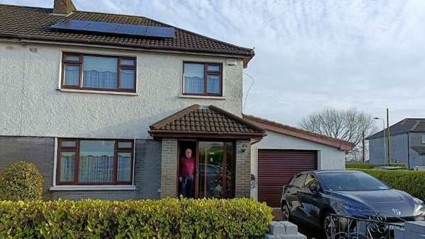 Gerald Bruton outside his house with new solar panels and electric car. Photo: Ken Bruton