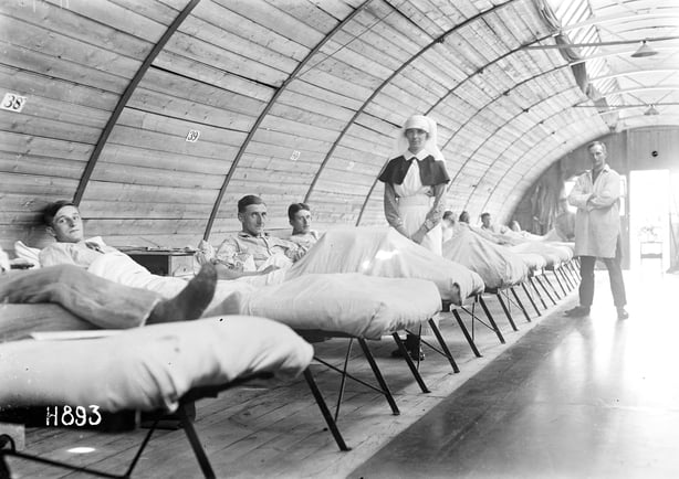 Nurse and patients in the New Zealand Stationary Hospital, Wisques, France, New Zealand nurse, Margaret McKenzie, and a row of patients in a ward of the New Zealand Stationary Hospital, Wisques, France. Photograph taken during World War I. (Photo by: Sepia Times/Universal Images Group via Getty Images)