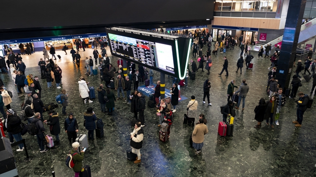 Passengers at Euston station, London, following train delays as Storm Isha brings severe disruption to rail services