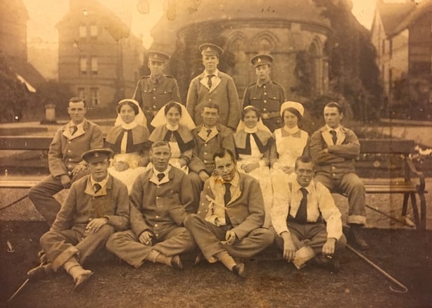 Group photo in sepia of nurses and men