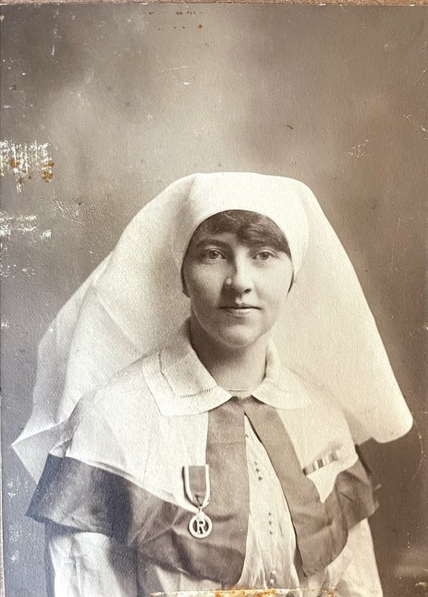 Sepia photo of Anna Meany, a dark haired white woman, in a nursing uniform