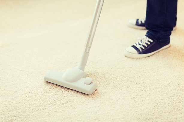 Person vacuuming carpet