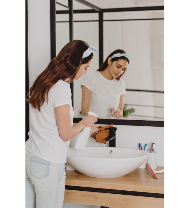 Woman cleaning bathroom basin