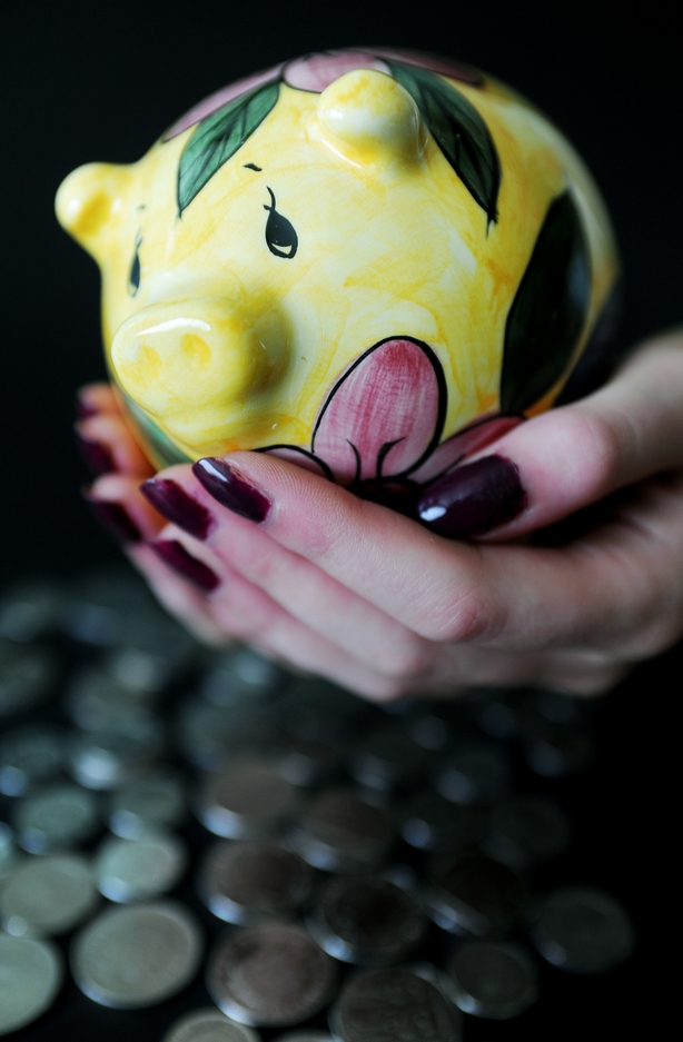 A piggy bank being held