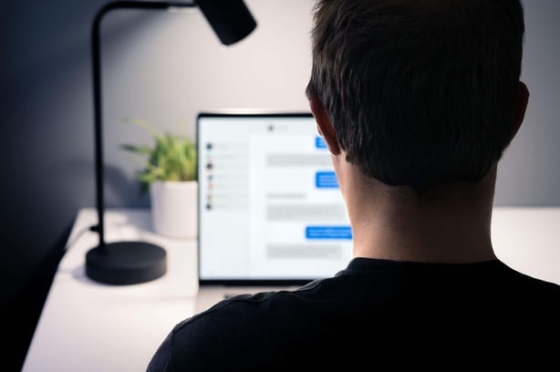 A man using an instant messaging service on a laptop (Alamy/PA)