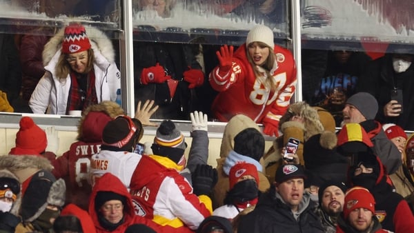 High five: Taylor Swift celebrates with Kansas City Chiefs fans during the NFL game against the Miami Dolphins. Photo: by Jamie Squire/Getty Images