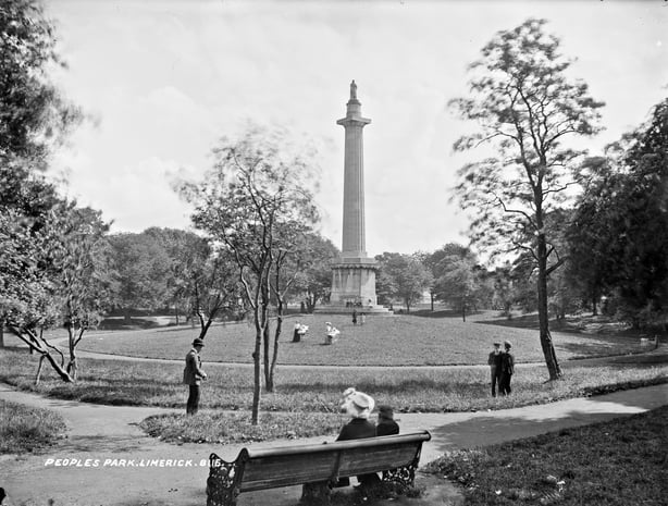 Black and white photo of a hill in. the centre of a park