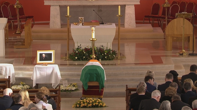 The tricolour draped over John Bruton's coffin as it lies in the church
