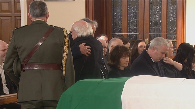 President Michael D Higgins is seen with John Bruton's brother, Fine Gael TD Richard Bruton, in the church