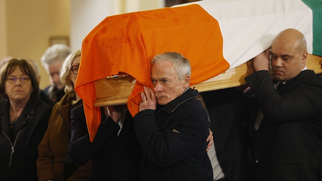 John Bruton's brother, former minister Richard Bruton, carries his coffin into the church