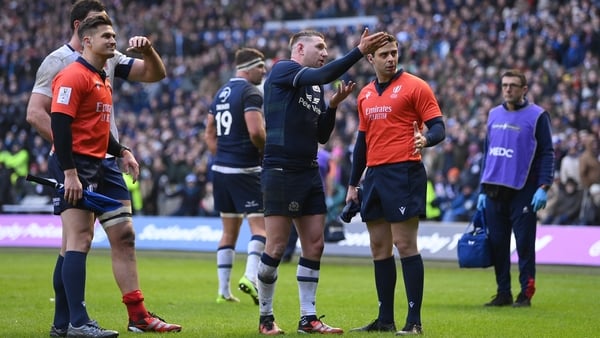 Scottish out-half Finn Russell talks to match officials while waiting for a TMO decision at the end of the game