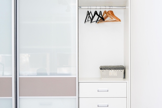 Wardrobe with empty shelves and hangers