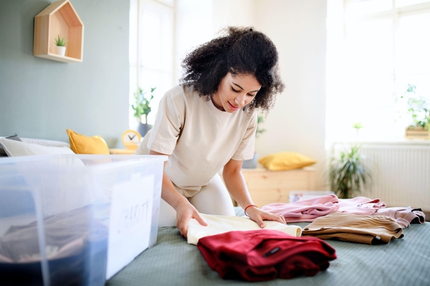 Woman sorting clothes from wardrobe