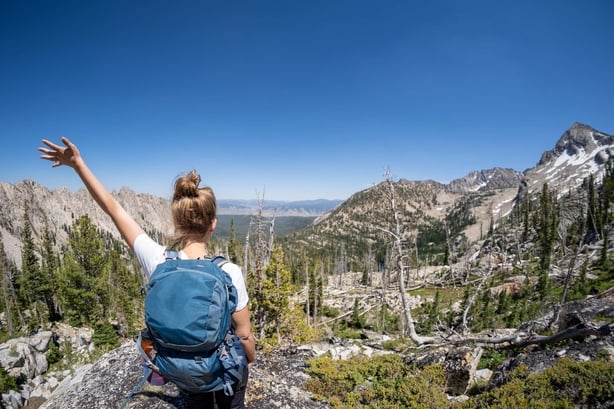 Female hiker with backpack along the Sawtooth Lake trail in Idaho. 
