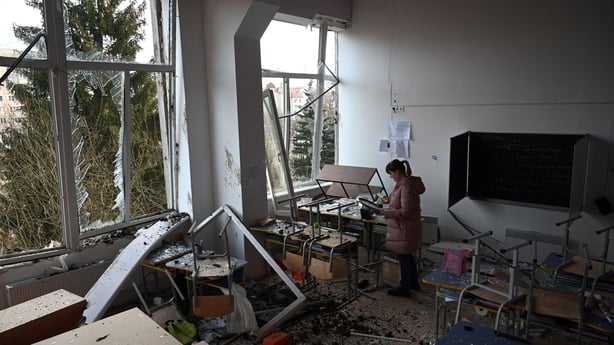 A school director inspects a classroom damaged as a result of a missile attack in Lviv on 15 February