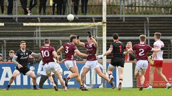 Niall Morgan gets forward to kick a point for Tyrone against Galway