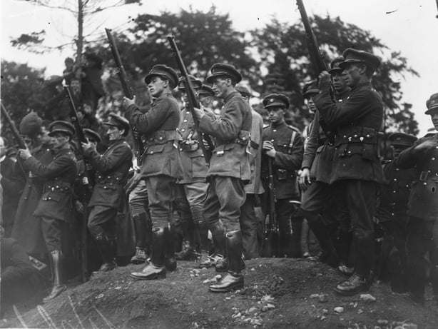 August 1922: Soldiers of the Irish Free State Army firing a salute at the funeral of 12 Free State soldiers in Dublin.