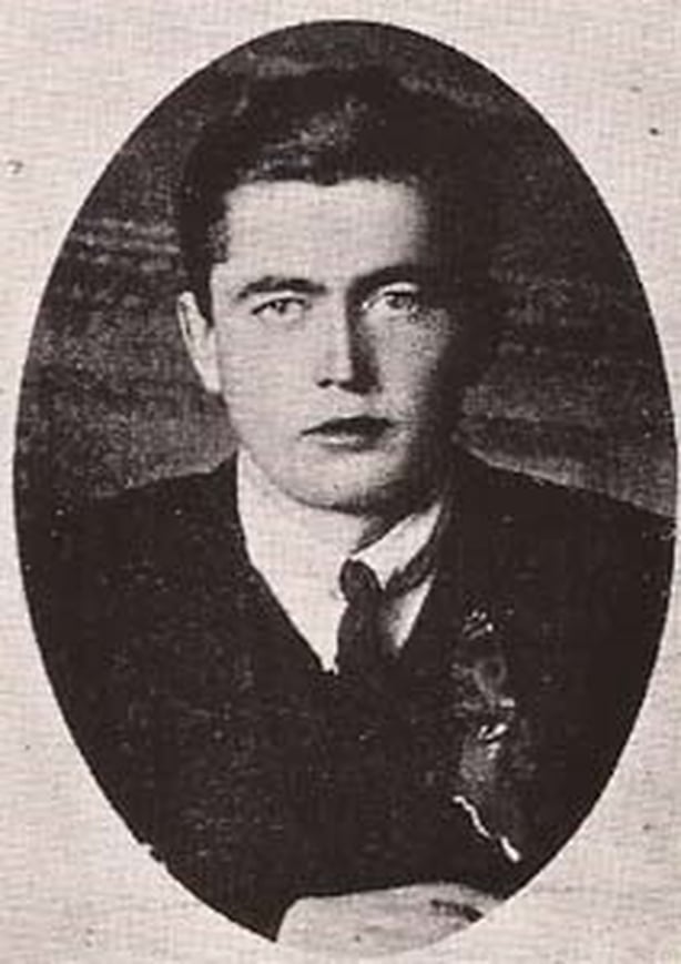 Black and white photo of young man with dark hair looking at the camera