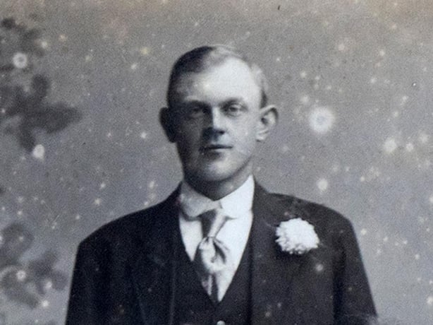 Black and white photo of bespectacled young man with fair hair. 