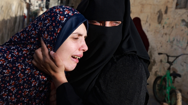 Rania Abu Anza (L) the mother of twin babies Naeem and Wissam, killed in an overnight Israeli air strike, mourns their death ahead of their burial in Rafah 