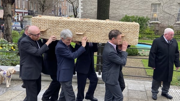 The wicker coffin carrying the remains of Charlie Bird is brought to the Mansion House