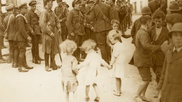 Barefoot children look on as National Army troops gather in Bruff, County Limerick after taking the town in early August 1922. Image courtesy of the National Library of Ireland