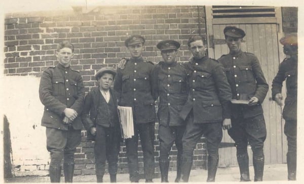 A newsboy poses with some National Army soldiers. Image: Seán Sharkey Collection. Courtesy of Neil Sharkey, Tipperary Studies