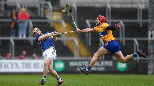 Jake Morris of Tipperary (L) has his shot blocked by Clare's John Conlon