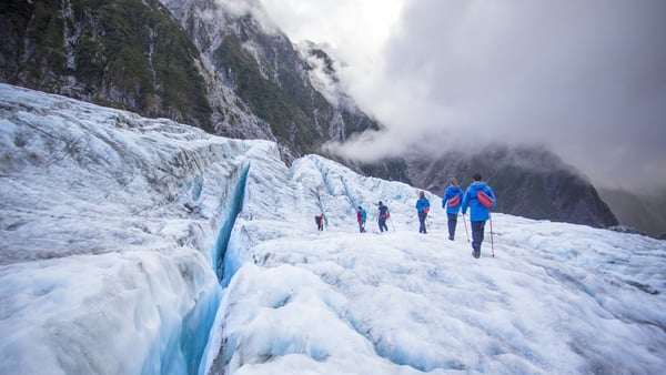 Travelers explore New Zealand's famous Franz Josef Glacier