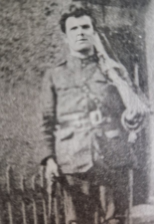 A black and white photo of a young man in uniform