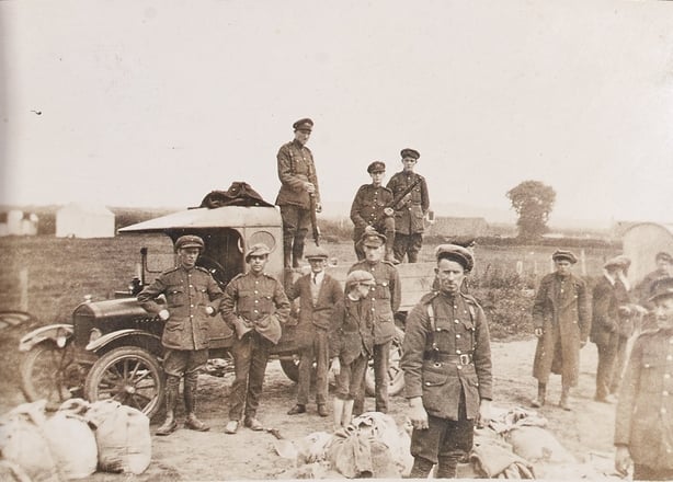 Soldiers standing around a tractor