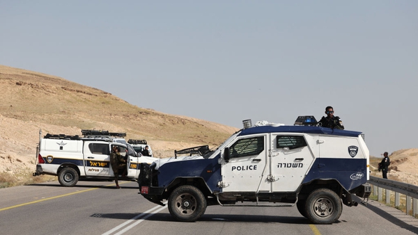 Israeli security forces on a road in the occupied West Bank following the shooting