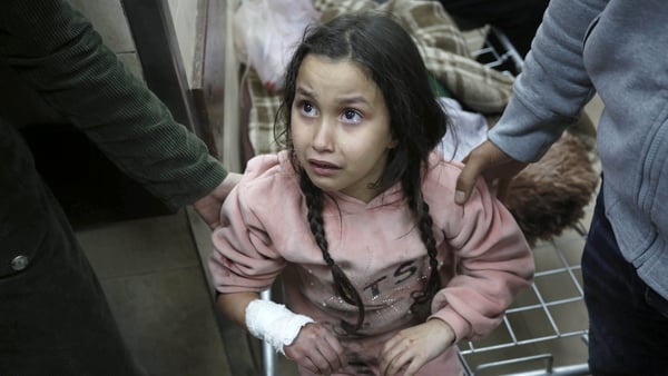 A little girl waits for treatment at Al-Aqsa Martyrs Hospital following Israeli airstrikes on Deir al-Balah