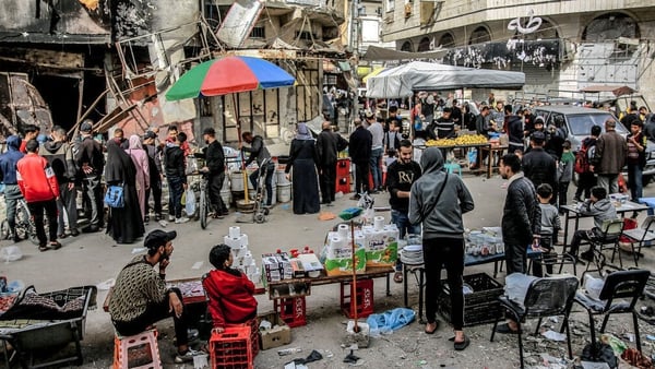 People shop for dwindling supplies at a market in Gaza City