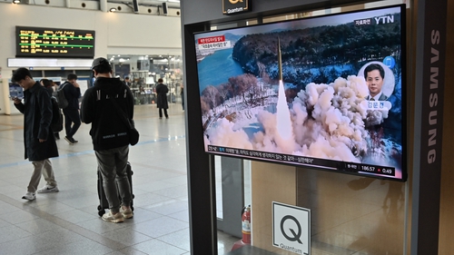 A TV in a Seoul train station shows file footage of a North Korean missile test